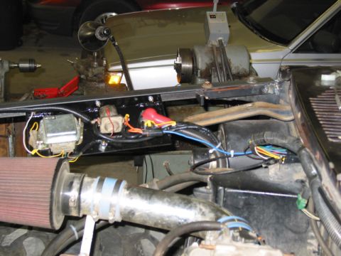 1981 Ford Bronco - Close-up view of engine bay modifications and electrical wiring, with a metal lathe in the background.