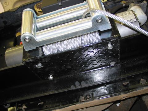 1981 Ford Bronco - A winch and steel cable are mounted on a black diamond plate bracket.
