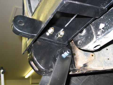 1981 Ford Bronco - A black metal bracket, likely for a winch, is attached to the vehicle's frame with bolts.