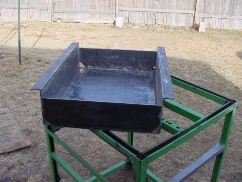 1981 Ford Bronco - A fabricated metal container sits on a green metal stand outdoors.