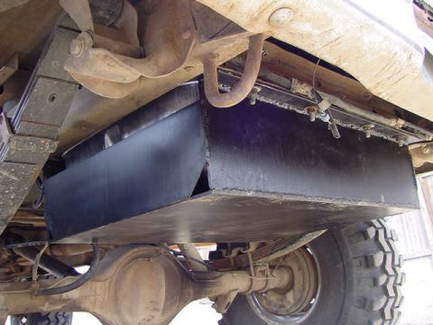 1981 Ford Bronco - This image shows the underside of a vehicle, focusing on the gas tank skid plate and suspension system. The registry claims it is a 1981 Fo…