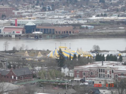 1993 Ford Bronco - A large circus tent is visible in the distance, set against a backdrop of buildings and a river.