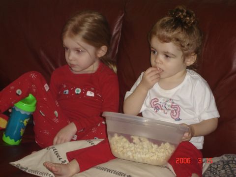 1993 Ford Bronco - Two young girls enjoy popcorn while sitting on a couch.