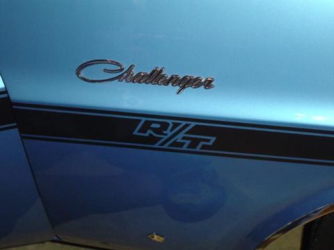 1979 Ford Bronco - The side panel of a blue vehicle displays the 'Challenger R/T' emblem and a black racing stripe.