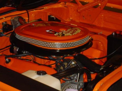 1979 Ford Bronco - The engine bay is painted orange and features a custom air cleaner assembly with "Coyote Duster" graphics.