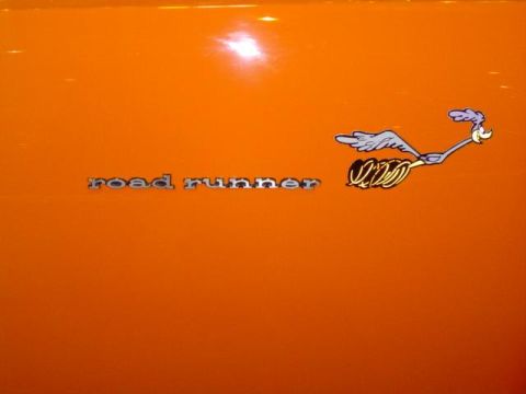 1979 Ford Bronco - A close-up of an orange vehicle's side panel displays the iconic Road Runner emblem and text.
