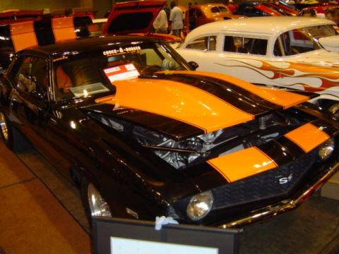 1979 Ford Bronco - A black 1969 Chevrolet Camaro SS with orange stripes is displayed with its hood open.