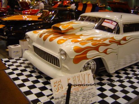 1979 Ford Bronco - Custom 1955 Chevy station wagon with flame graphics and a prominent hood scoop is displayed indoors.