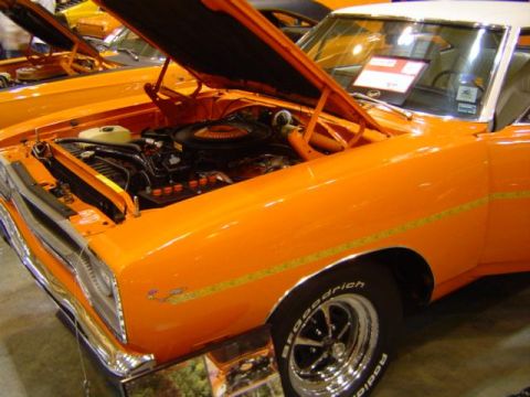 1979 Ford Bronco - This orange muscle car, likely from the early 1970s, is displayed with its hood open, revealing the engine compartment.
