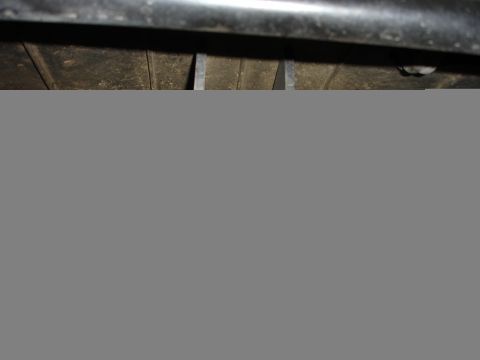 1996 Ford Bronco - Close-up view of a vehicle's undercarriage, showing structural components and suspension elements.