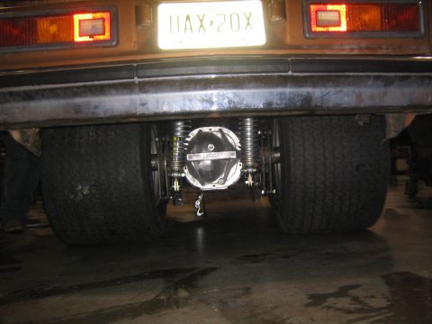 1978 Ford Bronco - The rear end of a custom vehicle is shown with a prominent differential and large tires.