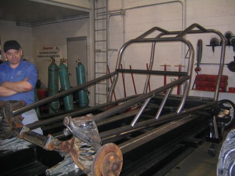 1978 Ford Bronco - A custom-built tube chassis is shown in a workshop setting, with a man standing nearby.