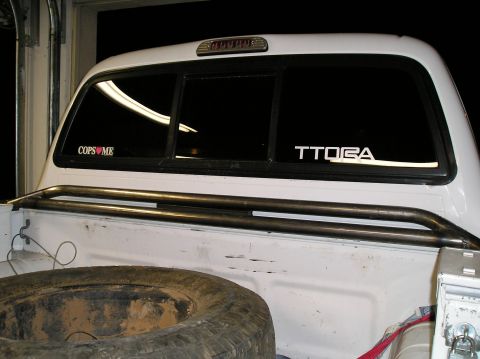 1993 Ford Bronco - A white SUV is viewed from the rear, showing the back window and a portion of the body.