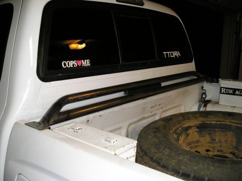 1993 Ford Bronco - Rear view of a 1993 Ford Bronco, showing the cargo space and spare tire cover.