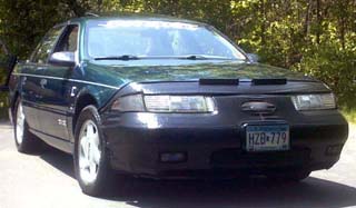 1993 Ford Taurus - A green 1993 Ford Taurus is shown from the front, equipped with a car bra.
