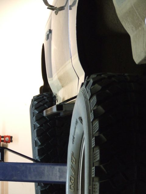1986 Ford Bronco - This 1986 Ford Bronco is equipped with large off-road tires and custom rock sliders, as seen from the side.