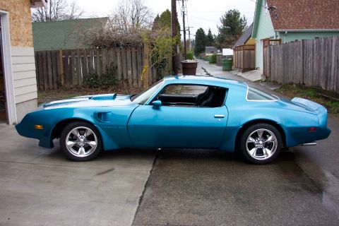 1979 Pontiac Trans Am - Side view of a blue 1979 Pontiac Trans Am with aftermarket wheels.