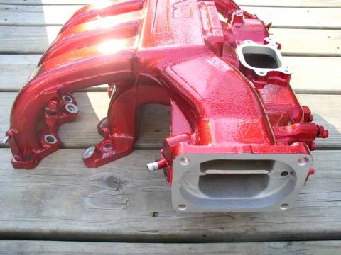 1996 Ford Probe - Red intake manifold shown on a wooden deck.
