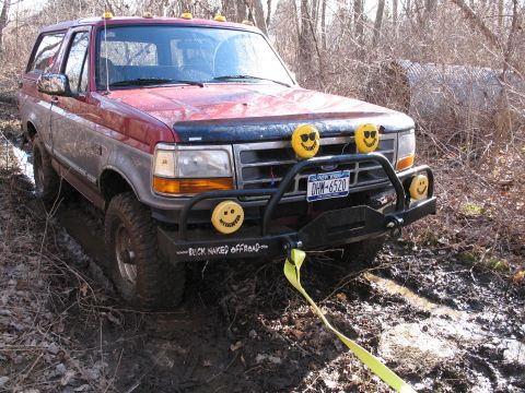 1995 Ford Bronco - This Ford Bronco appears to be from the early to mid-1990s, stuck in a muddy off-road trail.