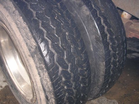 1986 Jeep J-10 - Close-up view of dual rear tires on a vehicle. The registry claims this is a 1986 Jeep J-10, but the image only shows tires.