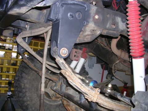 1986 Jeep J-10 - Undercarriage view of a 1986 Jeep J-10, showing suspension and steering components.