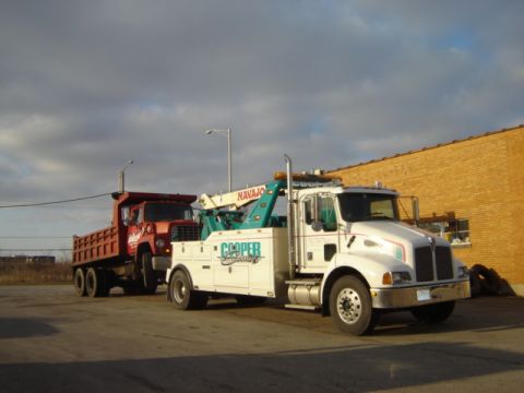 1992 Ford Bronco - A tow truck is towing a red dump truck. The tow truck has 'Cooper Service' and 'Navajo' text visible.