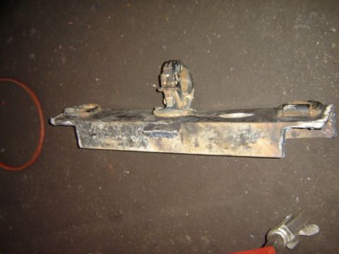 1992 Ford Bronco - This is a close-up of a metal vehicle part, likely from a tow hitch assembly, showing signs of wear and tear.