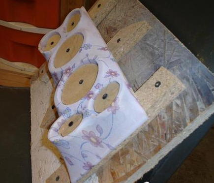 1984 Ford Bronco - A custom dashboard speaker enclosure, covered in floral fabric, is mounted on wood.