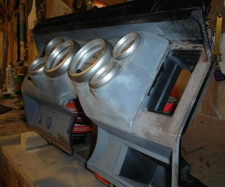 1984 Ford Bronco - This custom dashboard assembly features several gauges and is in a workshop setting.