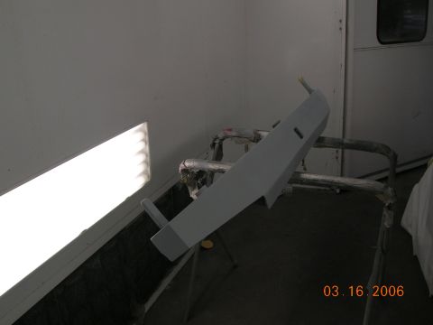 1985 Ford Bronco - A car bumper is prepped for painting in a workshop, with a date stamp of 03.16.2006 visible.