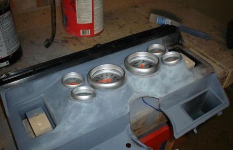 1984 Ford Bronco - A gray dashboard panel with several gauges is shown, possibly undergoing customization.