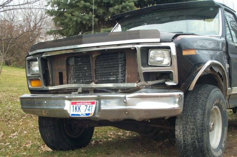 1984 Ford Bronco - This Ford F-150 shows damage to its front end, including a missing grille and fender.