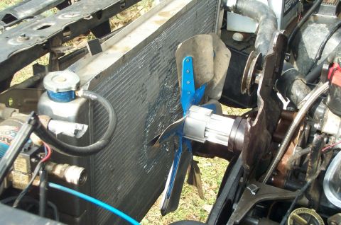 1984 Ford Bronco - The radiator and fan assembly are visible in this close-up shot of a vehicle's engine compartment.