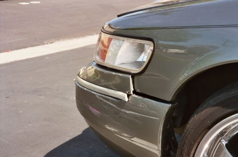 2000 Mercury Grand Marquis - Front passenger side damage on a 2000 Mercury Grand Marquis, including a misaligned bumper cover.