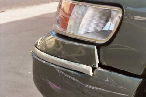 2000 Mercury Grand Marquis - The front corner of this 2000 Mercury Grand Marquis shows significant damage to the bumper and trim, indicating a recent impact.