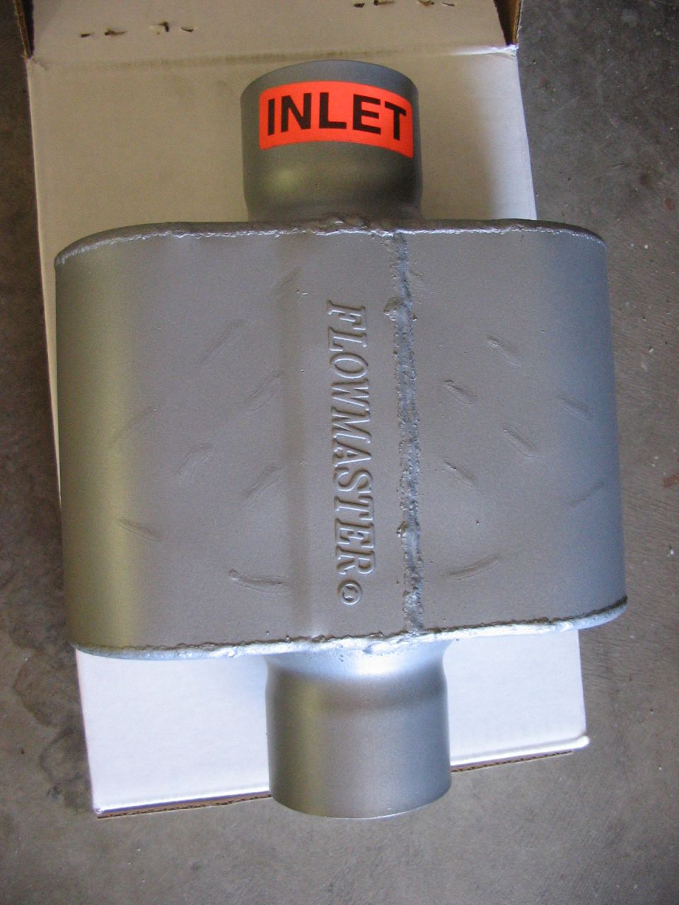 Flowmaster muffler with orange 'INLET' sticker