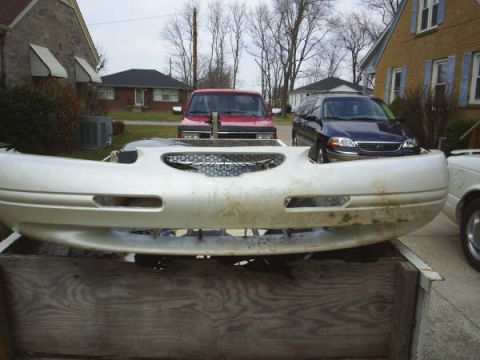 1996 Ford Thunderbird - A detached front bumper is shown in the foreground, with other vehicles visible in the background.