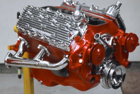 1978 Ford F-250 - A red V8 engine with chrome accents is displayed on a yellow stand.