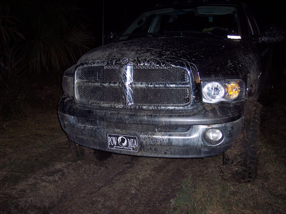 Front view of a muddy Dodge Ram pickup truck with a POW MIA license plate
