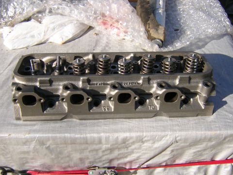 1979 Ford Bronco - Close-up of an engine cylinder head, showing internal components like valves and springs.