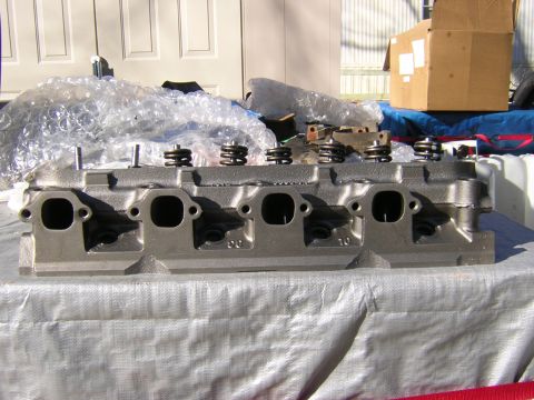 1979 Ford Bronco - Engine cylinder head with springs and valves. Stamped part numbers are visible on the casting.