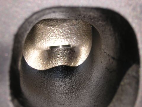 1979 Ford Bronco - Intake port of a cylinder head, showing the valve seat and port casting texture.