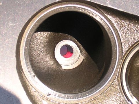 1979 Ford Bronco - A close-up view of an engine cylinder head, showing internal ports and a hint of red fluid.