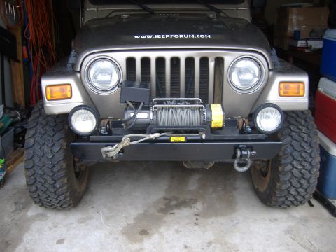 2004 Jeep Wrangler - This Jeep Wrangler features a winch and an aftermarket bumper, with a website address visible on the hood.