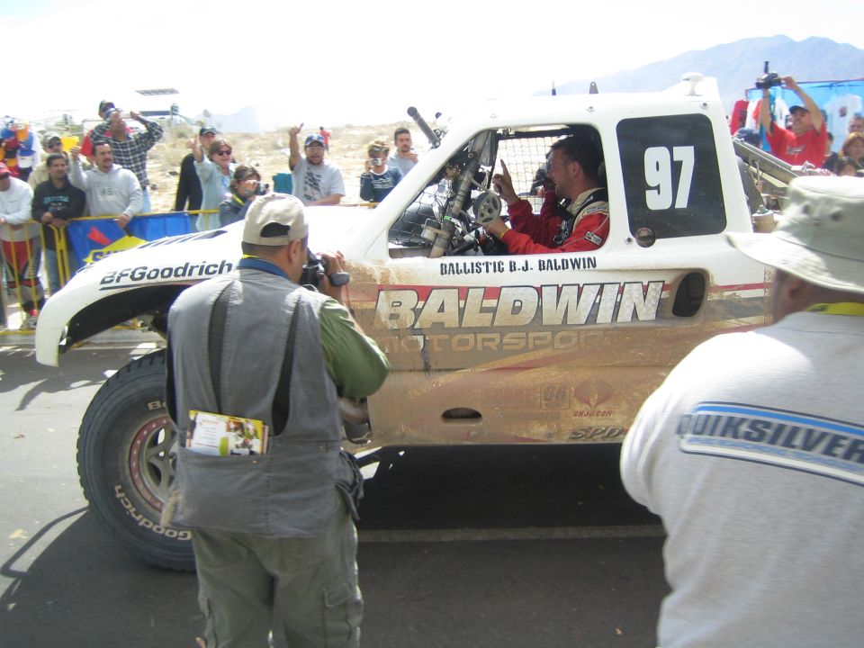 White off-road race truck number 97 with Baldwin Motorsports and BFGoodrich graphics at a desert race finish