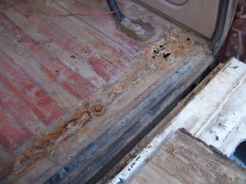 1988 Ford Bronco - The interior floor pan shows significant rust and damage, indicating poor condition.