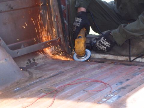 1988 Ford Bronco - Grinding rust off the interior floor of a vehicle.