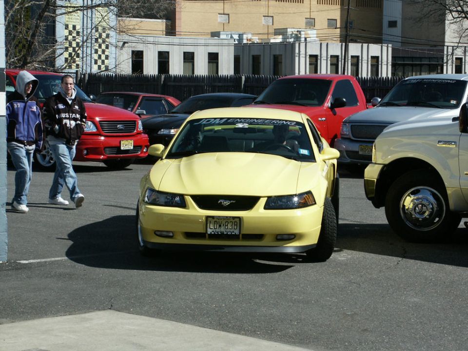 Yellow 2001 Ford Mustang with JDM ENGINEERING banner