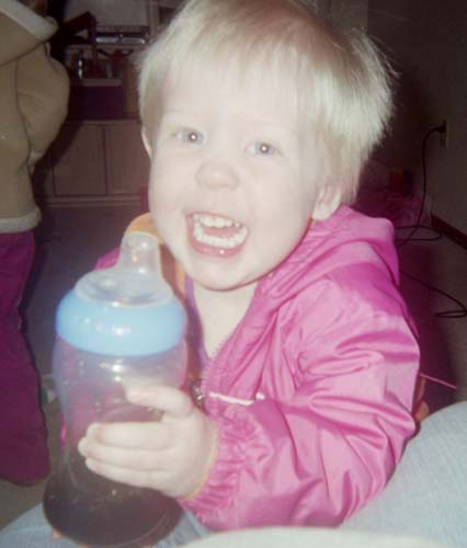 2002 Oldsmobile Aurora - A child holds a bottle while looking at the camera.