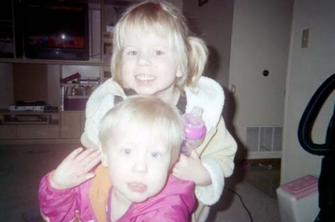 2002 Oldsmobile Aurora - Two young children are the focus of this indoor photograph, with a entertainment center in the background.
